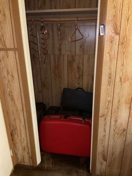 Contents of closet: luggage, hangers