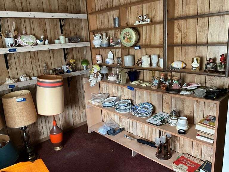 Contents of corner shelves: souvenir plates, Westmoreland fairy lamp, figurines, decor items, misc