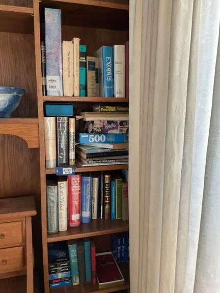 Four shelves of books: novels, biography, reference, misc