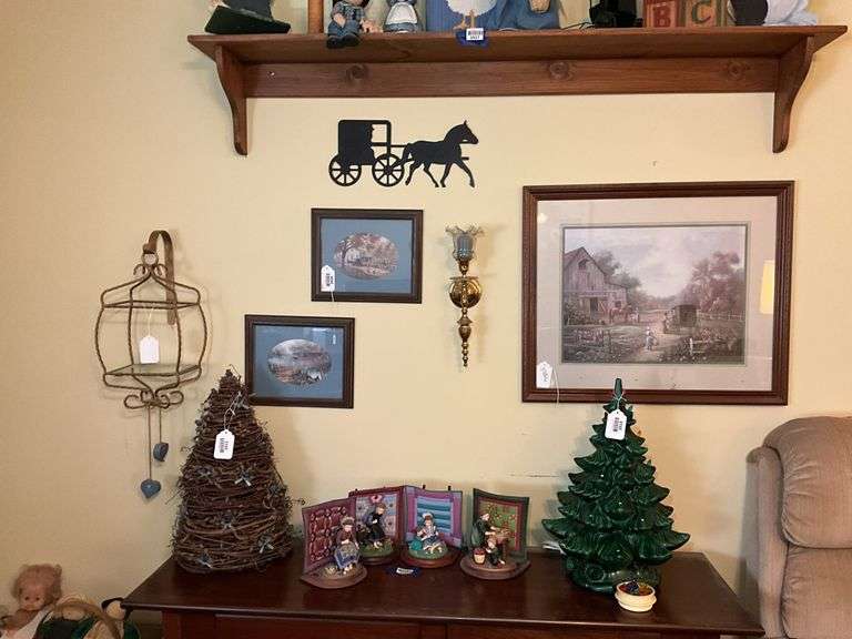 Wall hangings: framed farm prints, candle sconce, wire display cage, buggy cutout plaque