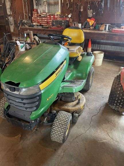 John Deere model X 300 riding mower. Needs a battery. Inspection encouraged. Shows wear