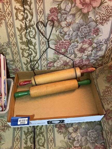 Two vintage wooden rolling pins and wire bracket