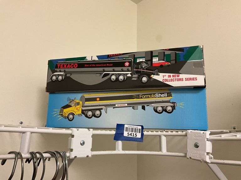Two tanker truck models in boxes: Texaco, Shell