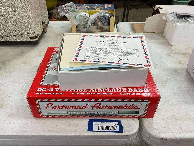 Two model airplanes in boxes: Danbury Mint The Spirit of St. Louis, and North Pole Airways bank
