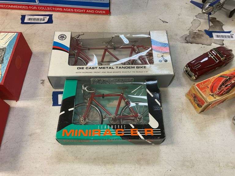 Two model bicycles in boxes including tandem bike