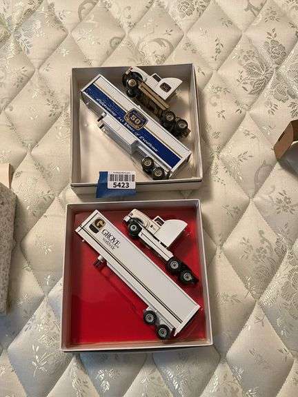 Two Grove truck models in boxes