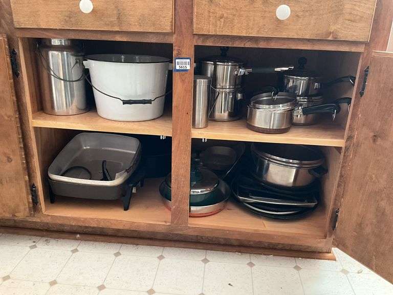 Contents of cupboard: Revere Ware cookware, electric skillet, enamel bucket