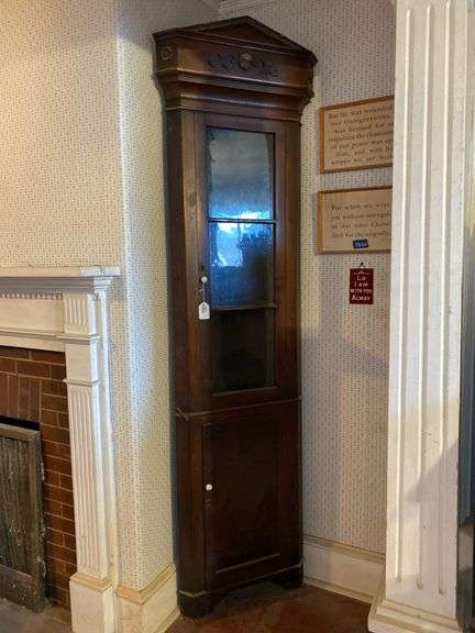 Corner cupboard and framed picture of Dr. Senseny, cupboard has tall/narrow proportions, triangular pediment over cove molded cornice, glazed top door, paneled bottom door, porcelain knobs, Believed to have belonged to Dr. Senseny and was saved from the burning of Chambersburg, Pa. Practiced in Chambersburg Pa, had 3 sons in the medical corp of the army of the Potomac. Estimated to be close to the civil war. 24x12x96