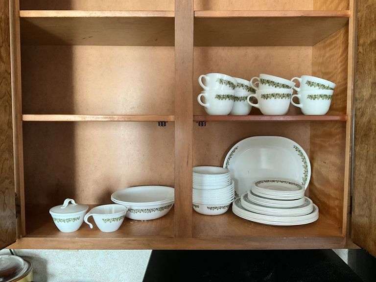 Contents of cupboard: Corelle green Spring Blossom dinnerware