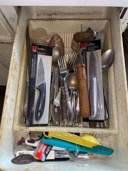 Contents of drawer: knives, flatware, utensils, sterling content