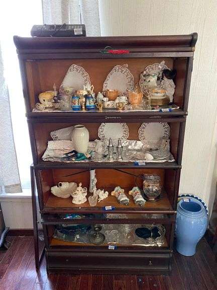Mahogany finish 4-section barrister bookcase w/ drawer in base - note one door is unattached - no contents 34x12x59 - MUST COME DURING LAST 2 HOURS OF PICKUP FOR THIS ITEM
