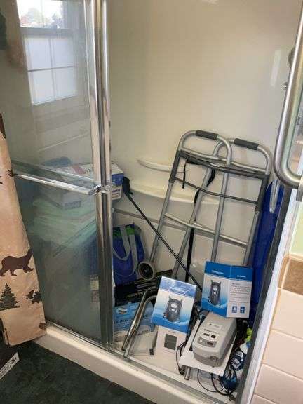 Contents of bathroom: walker, health & handicap products, outhouse prints, blow dryer, linens, misc