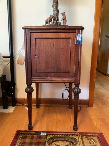 1920s end stand w/ trumpet legs - no top contents 16.25x15.75x30. Couldn’t open door due to lack of handle