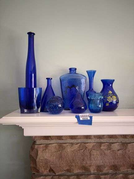 Cobalt blue glass paperweights, vases, and bottles
