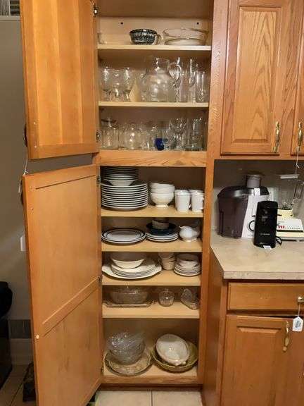 Contents of two cupboards: glass bakeware, stemware, glasses, various dinnerware
