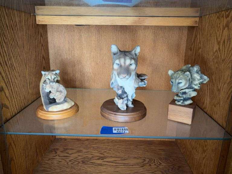 Three mountain lion figurines