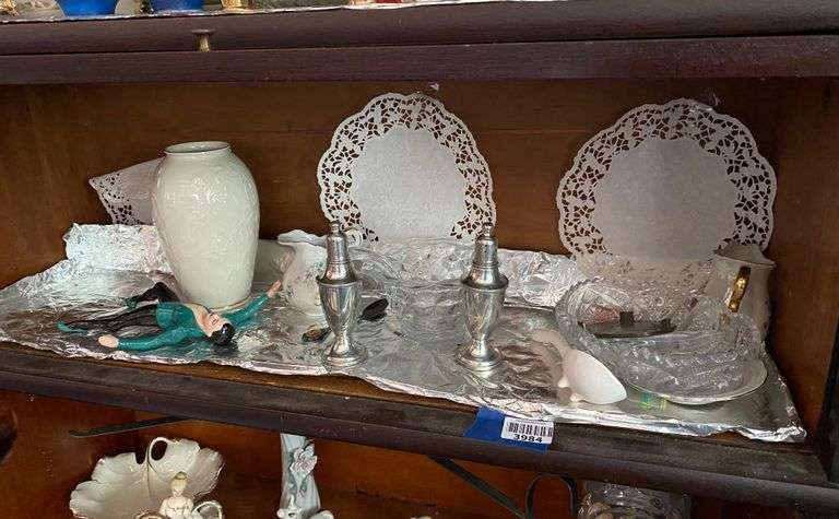 Contents of shelf: Lenox china vase, salt/pepper shakers, ceramic dancer figurine, Fostoria American mayonnaise dish, 50th anniversary creamer, misc