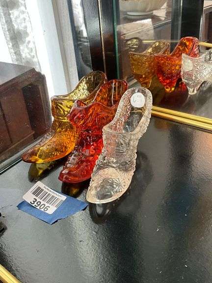 Three Fenton glass shoes: amber, amberina, clear