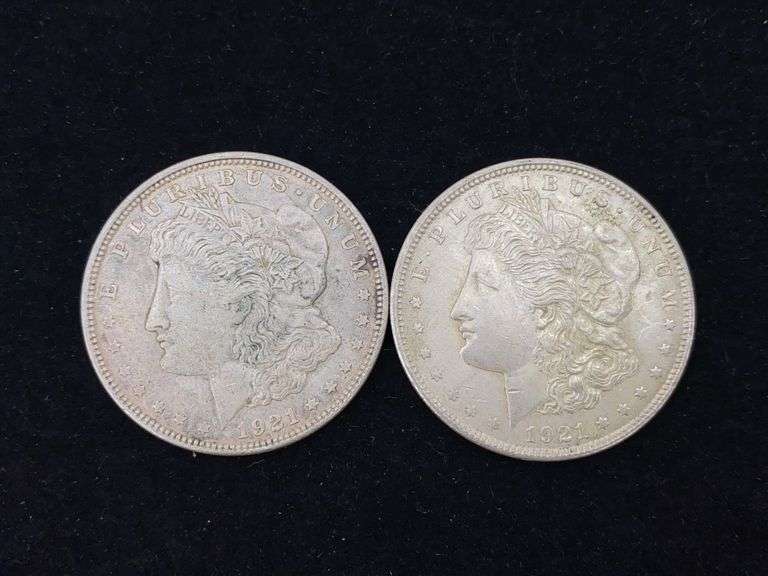 Two 1921 Morgan silver dollar coins - by the pc take two