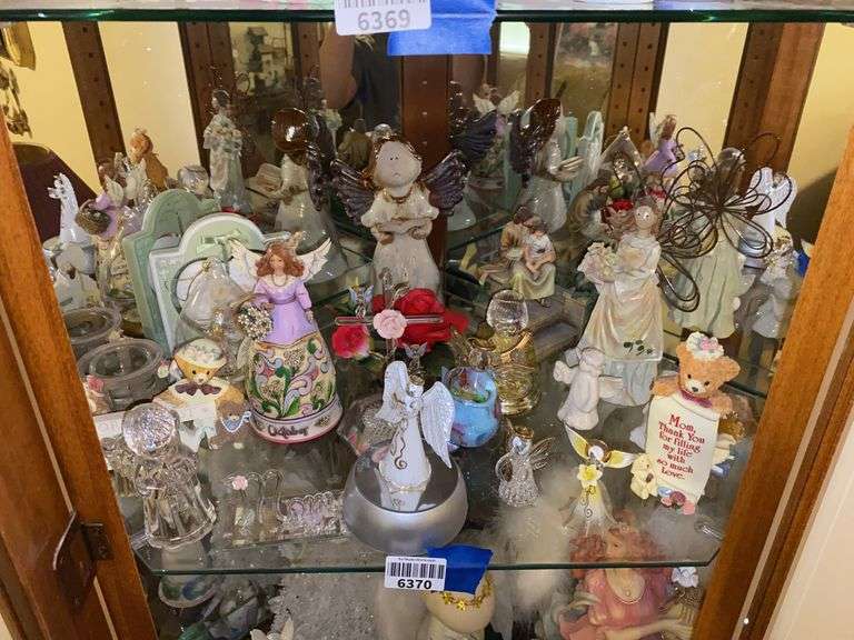 Contents of shelf: angel and Teddy bear figurines