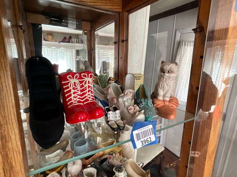 Contents of shelf: shoes in ceramic, porcelain, misc