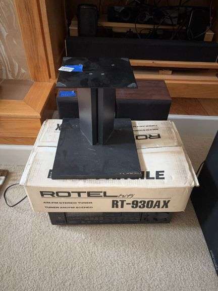 Rotel AM/FM stereo tuner in box, Onkyo tuner/amplifier, pair of speakers, and stand