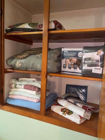 Contents of cupboard: quilt, comforter, sheets, mattress cover
