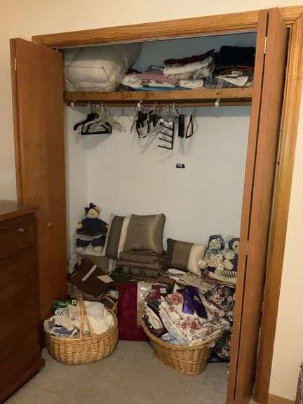 Contents of closet: comforter, sheets, Teddy bears, throw pillows, linens