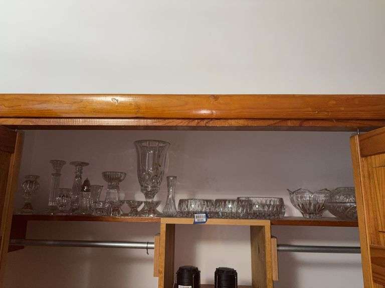 Contents of shelf: crystal candleholders, candle lamp, sugar shaker, bowls,