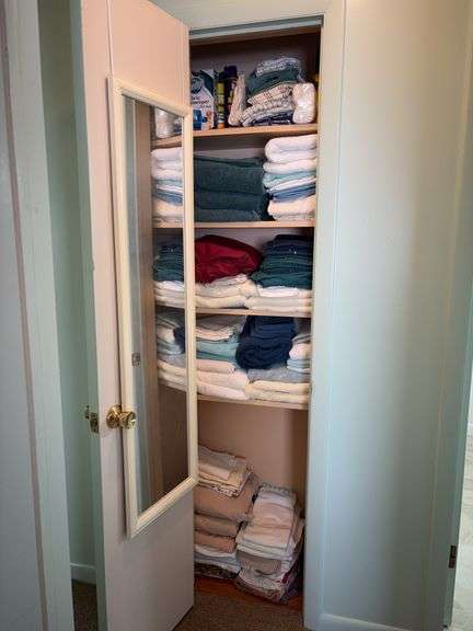 Contents of closet: towels, sheets, blankets, misc