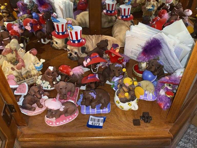 Contents of shelf: dog figurines