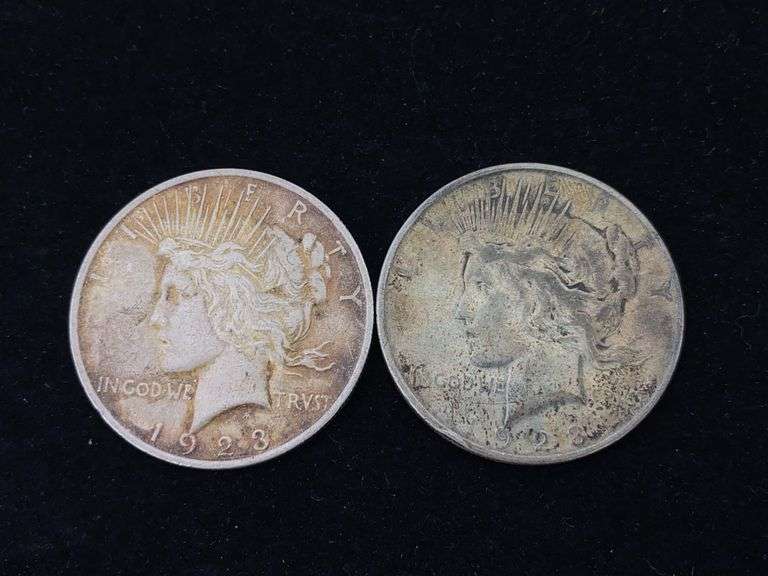 Two 1923 Peace silver dollar coins - by the pc take two