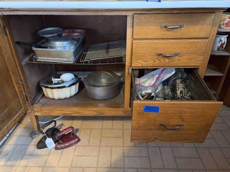 Contents of base cupboard and drawer: cookware, baking pans, kitchen gadgets