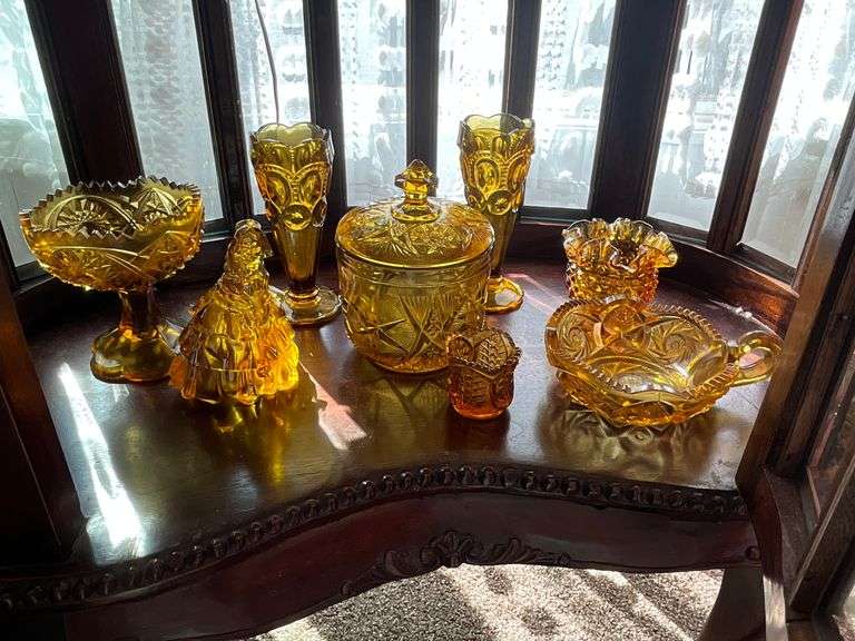 Amber glassware including: pedestal dish, Moon & Star vases, figurine, covered jar, toothpick, nappy