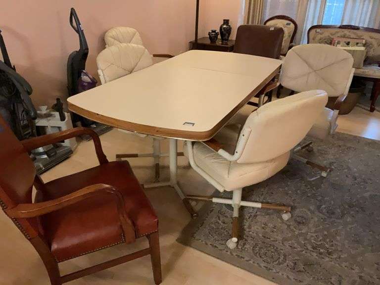 Twin pedestal extension dining table w/ oak trim, one leaf, and set of four matching swivel chairs 36 x 71