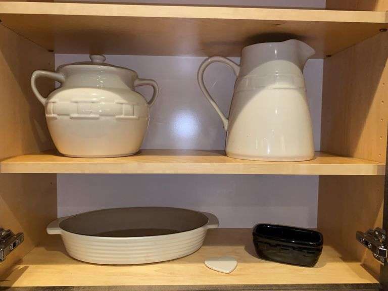 Contents of two shelves: Longaberger pottery beanpot, pitcher, baking dish, small dish