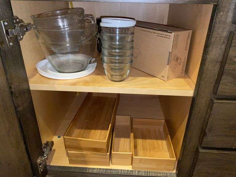 Contents of cupboard: Pampered Chef mandoline, measuring cups, small bowls