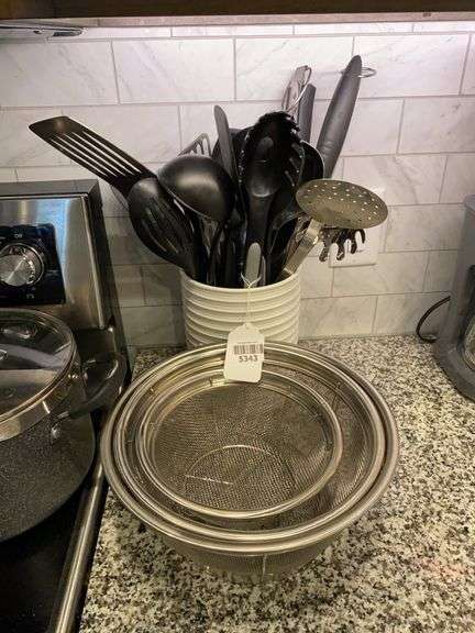Nest of strainers, crock of utensils