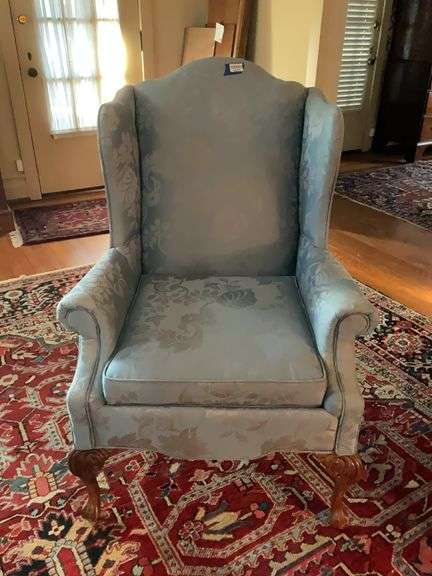 Wing chair in blue damask upholstery, carved cabriole legs