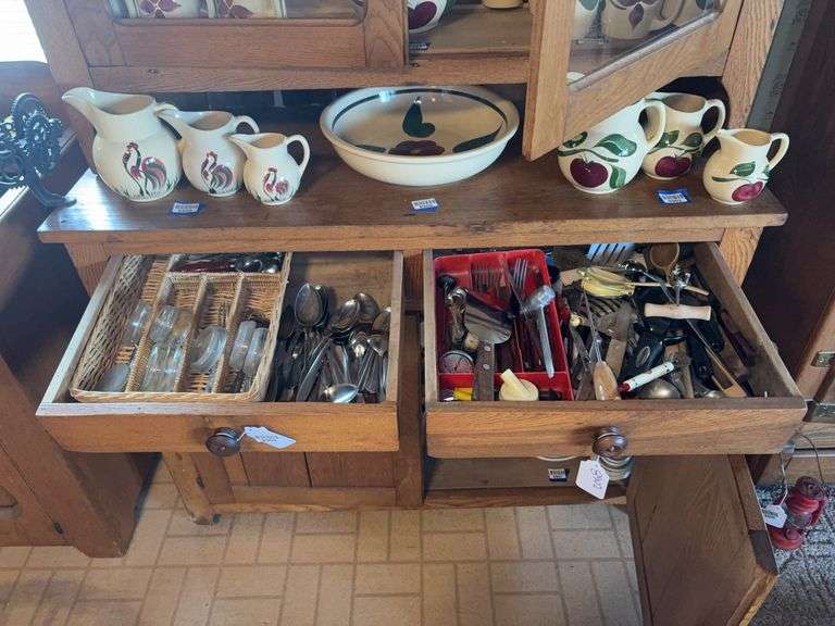 Contents of two drawers: flatware, utensils, furniture casters