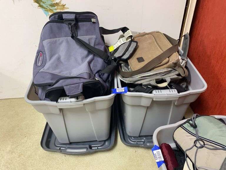 Two plastic totes of carry all bags
