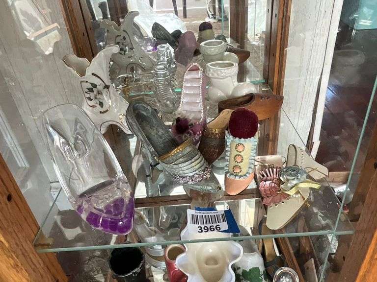 Contents of shelf: shoes in glass, ceramic, resin, wood