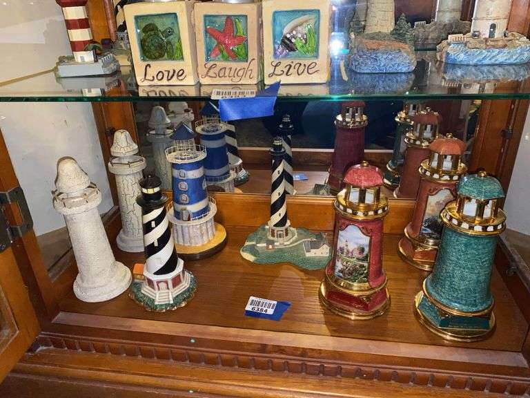 Contents of shelf: Thomas Kinkade and other lighthouse models