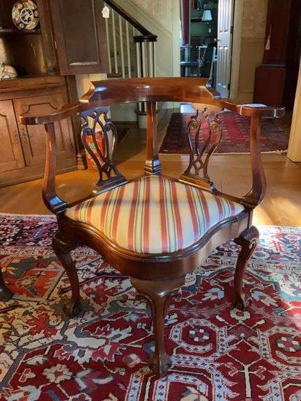 Chippendale roundabout/corner chair w/ pierced back splats, cabriole legs ending in claw & ball feet, striped upholstered seat