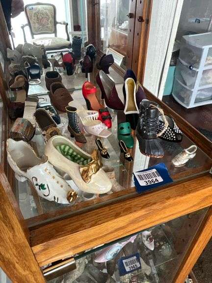 Contents of shelf: shoes in ceramic, porcelain, misc