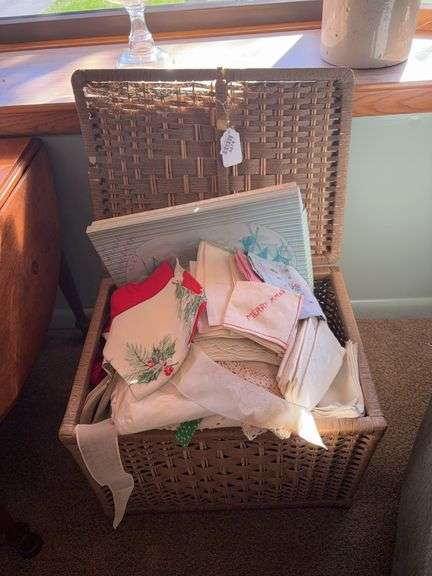 Wicker chest and linens contents: vintage Christmas apron, napkins, crochet work