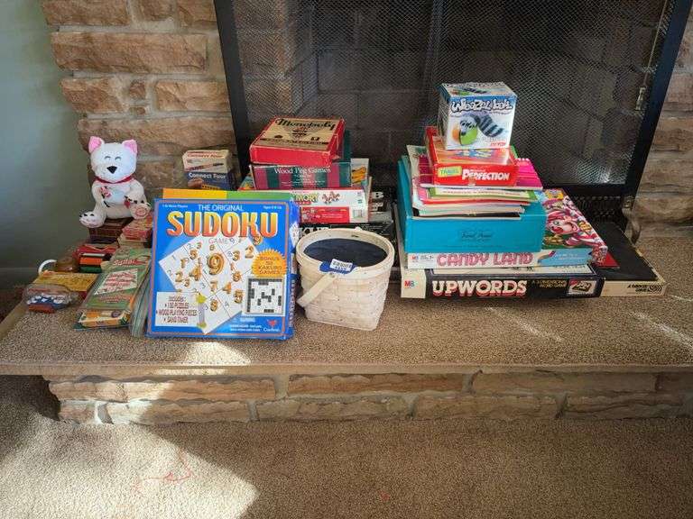 Contents of left end of hearth: games, toys, dice, plush dog