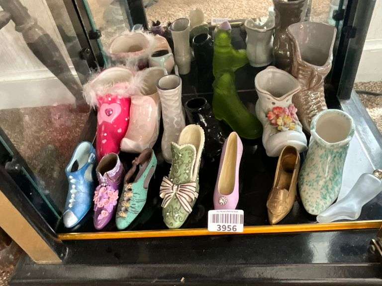 Contents of shelf: shoes in metal, glass, ceramic