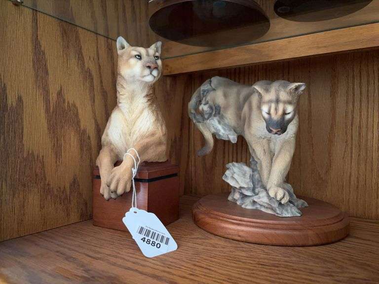 Two mountain lion figurines