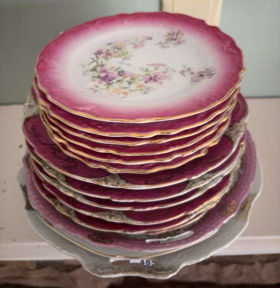 Antique decorated porcelain plates and open-handled cake plate